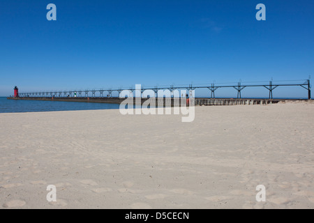 Beach with the Lake Michigan Lighthouse at Lake Michigan in the background, South Haven, MI, USA Stock Photo