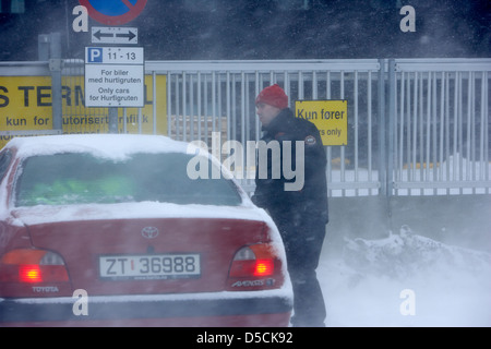 man getting into his car in blizzard covered in snow during winter hammerfest finnmark norway europe Stock Photo