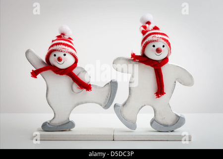 Two snowman decorations onbright white background Stock Photo