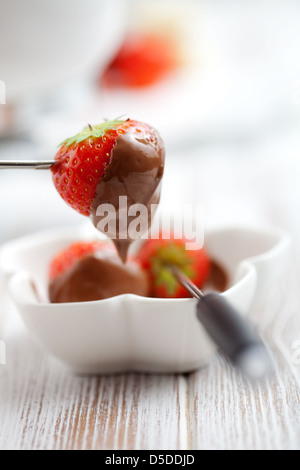 Chocolate fondue with fresh strawberries, selective focus Stock Photo