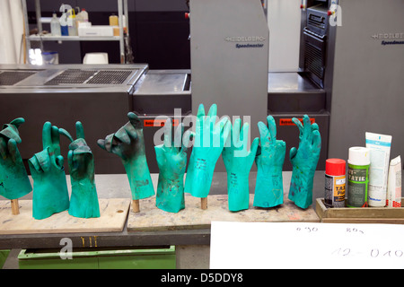 Geldern, Germany, green rubber gloves at the printers before a Heidelberg printing press Stock Photo