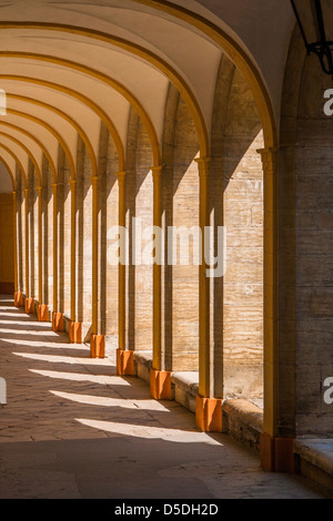 A corridor in a medieval cloister with sunlight Stock Photo
