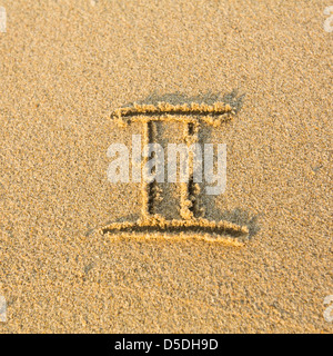 Zodiac sign Gemini, drawn on the facture beach sand. (zodiac signs series) Stock Photo