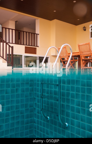 Swimming pool view from both above and under water simultaneously near the hotel building Stock Photo