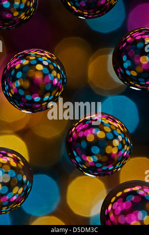 Multi colored balls against defocused light background Stock Photo