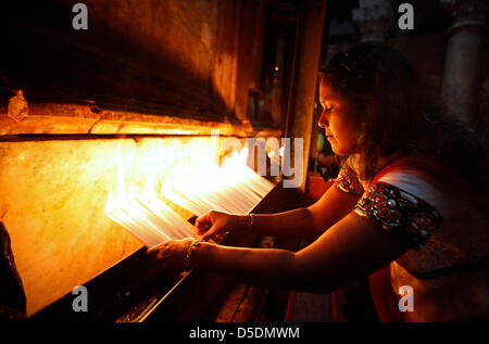 A Christian devotee from India lights candles during a procession inside the Church of the Holy Sepulchre, in the old city of Jerusalem Israel Stock Photo