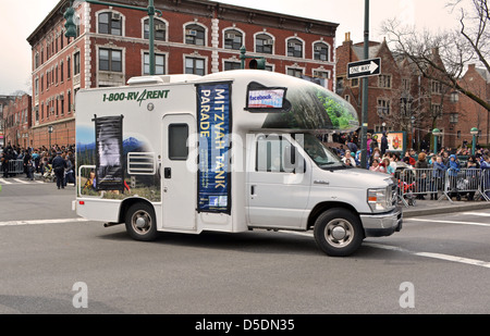 Mitzvah Tanks parading past Lubavitch headquarter to celebrate the birthday of the Lubavitcher Rebbe Menachem Mendel Schneerson. Stock Photo