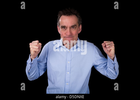 Angry Middle Age Business Man Shaking Fists in Frustration Black Background Stock Photo