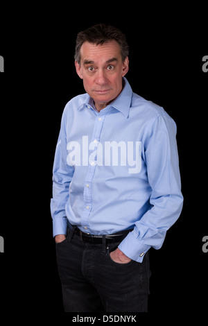 Surprised Shocked Staring Middle Age Business Man in Blue Shirt Black Background Stock Photo