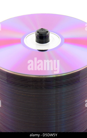 Purple CDs or DVDs on spindle, on white background. No dust. Stock Photo