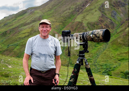 Portrait of professional photographer with large telephoto lens & tripod, Denali National Park, Alaska, AK Stock Photo