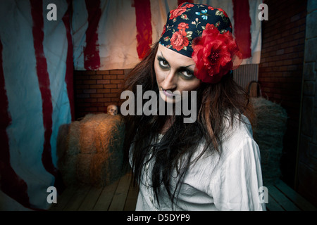 Dark gypsy woman front of dark tented alley Stock Photo