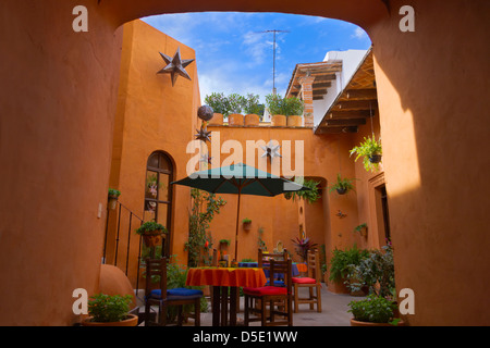 Dining table in the courtyard of colonial house, San Miguel de Allende, Mexico Stock Photo
