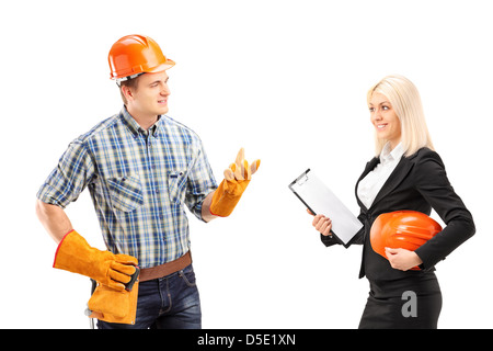 Male manual worker having a conversation with female architect, isolated on white background Stock Photo