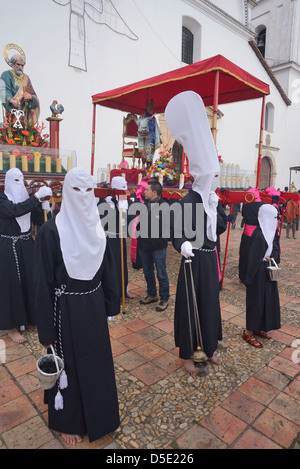 Masked men  in Penitence Costume for Easter, an ancient hispanic tradition. Tunja, Boyacá, Andes, Colombia, South America Stock Photo