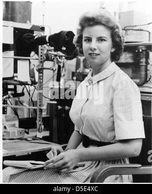 A photograph of Jacqueline L. Schroedter in the 1960s, working in a laboratory. Schroedter, a scientist at Lockheed, made significant contributions to the field of astronomy. The image reflects her role in scientific research during a period of significant advancement in space exploration. Stock Photo