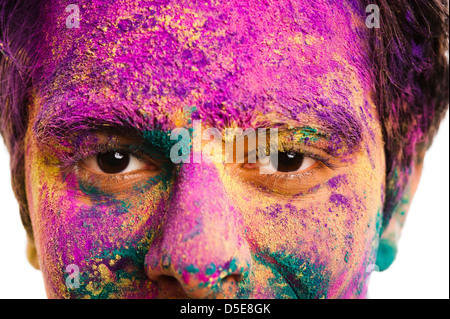 Mans face covered with powder paint during Holi festival Stock Photo