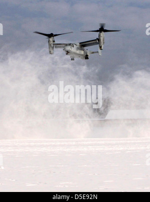 US Marine Corps MV-22B Osprey blows snow everywhere as it prepares to land at Stuttgart Army Airfield during an exercise March 29, 2013 in Stuttgart, Germany. Stock Photo