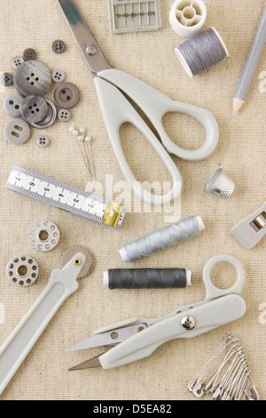 A collection of sewing, needlecraft, dressmaking, tailoring tools and items in harmonising neutral greys and beige Stock Photo