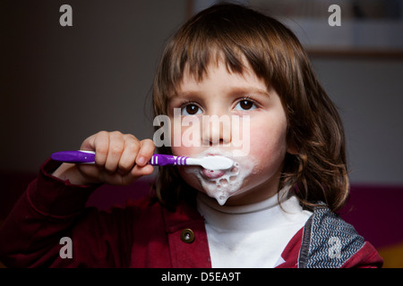 Four year old brushing his teeth Stock Photo