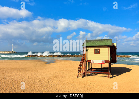 Wooden lifeguard station on empty beach under blue sky with white clouds on Mediterranean sea in Israel. Stock Photo