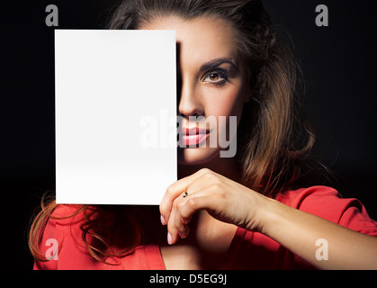 Beautiful woman holding an empty white sheet Stock Photo