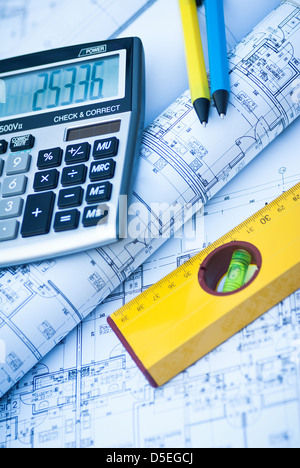 Construction rolls and plans and yellow helmet Stock Photo