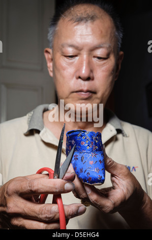 Artisan making shoes for 'bound feet', Melaka, Malaysia, Asia Stock Photo