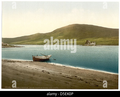 Doon Castle, located in Dalmellington, Scotland, is captured from the loch. The castle's historic structure stands near the water, creating a picturesque scene in this Scottish landscape. Stock Photo