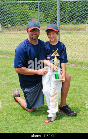Father and son baseball portrait holding trophy. Stock Photo