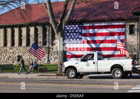 Putting out American flag before a parade on  Patriots day in Lexington,  Massachusetts, USA Stock Photo