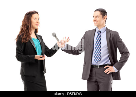 A businesswoman and male reporter having an interview, isolated on white background Stock Photo