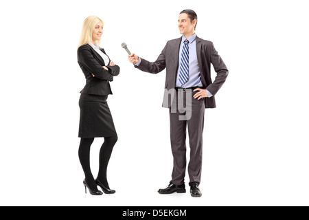 Full length portrait of a businesswoman and male reporter having an interview, isolated on white background Stock Photo