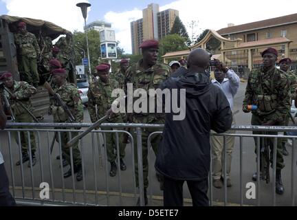 Nairobi, Kenya. 30th March, 2013. Officers with the Kenyan General Service Unit (a special division of the police department) detain a protester outside the grounds of the Supreme Court building. The court upheld Uhuru Kenyatta's presidential poll victory, rejecting challenger Raila Odinga's petition. Presidential, legislative and municipal elections were held on March 4. Mr. Odinga, who polled second, challenged the results; he said the vote was not credible because of failures with the electronic voter ID system and the vote counting mechanism. (Cre Stock Photo