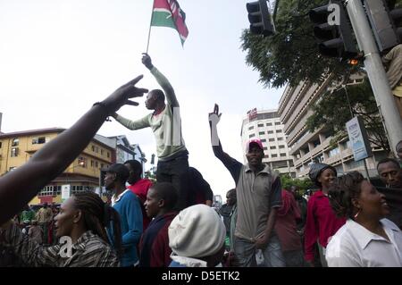 Nairobi, Kenya. 30th March, 2013. Supporters of Uhuru Kenyatta celebrate in the city center. The Supreme court upheld Uhuru Kenyatta's presidential poll victory, rejecting challenger Raila Odinga's petition. Presidential, legislative and municipal elections were held on March 4. Mr. Odinga, who polled second, challenged the results; he said the vote was not credible because of failures with the electronic voter ID system and the vote counting mechanism. (Credit Image: Credit:  Ric Francis/ZUMAPRESS.com/Alamy Live News) Stock Photo