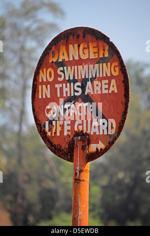 A noticeboard indicating No Swimming In This Area Stock Photo