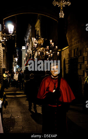 Barcelona, Spain. 29th March, 2013. The float of the 'Our Lady of Sorrows' brotherhood is carried for the Good Friday Procession through the Gothic quarter of Barcelona. - The brotherhood of 'Nuestra Senora de las Angustias' (Our Lady of Sorrows) is one of three brotherhoods organizing and participating in the Good Friday procession through the Gothic center in Barcelona followed by thousands of citizens and tourists. Stock Photo