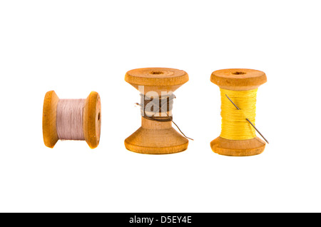 three old thread spools on isolated white background Stock Photo