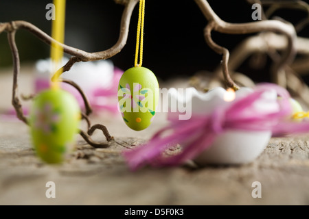 Easter candles on wooden table with egg decorations Stock Photo