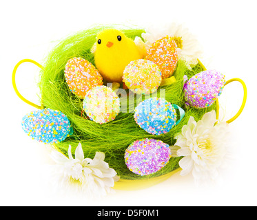 Original painted Easter eggs decorated with flowers and little yellow chick toy in basket isolated on white background Stock Photo