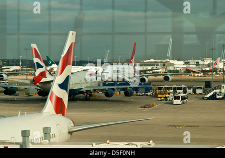 Aeroplanes on the tarmac at a Terminal Building in an airport Stock Photo