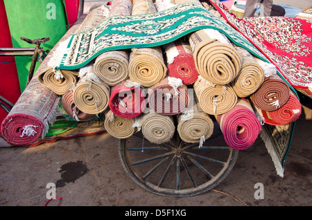 various colorful carpets rolls in Delhi market, India Stock Photo