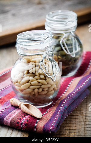 Close up of pine and pumpkin seeds in glass jar Stock Photo