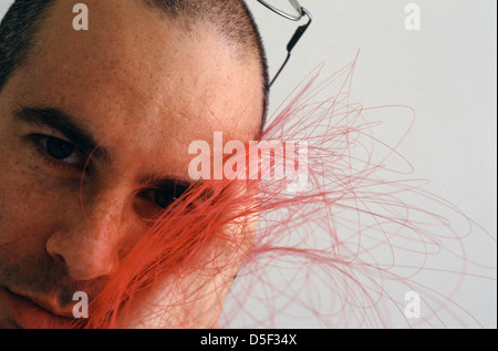 A man holding bundle of lightwave fibreoptic cables in a high tech company Israel Stock Photo