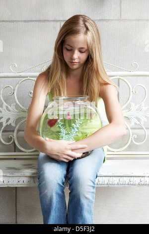 14 year old girl holding fish bowl Stock Photo