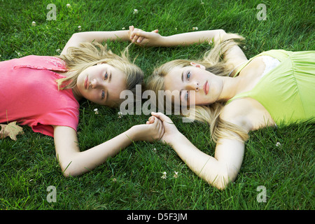 Three nude brunette Caucasian mid-adult women lying in 