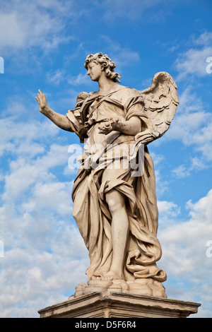 Angel with the Nail on Ponte Sant'Angelo, Rome, Italy, Angel created by renaissance artist, Bernini, against blue sky. Stock Photo