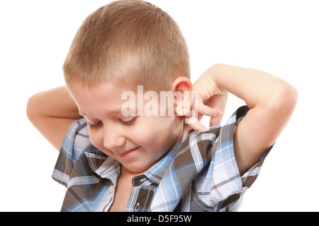 little boy buttoning on shirt, isolated on white background Stock Photo