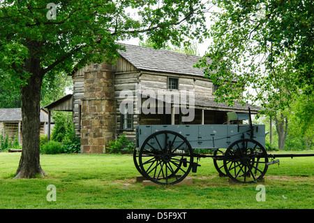 19th Century Wagon and log home in Prairie Grove Battlefield State Park, Arkansas Stock Photo