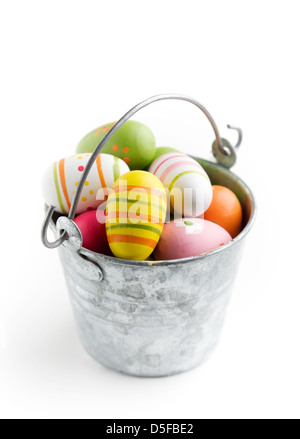 Colorful easter eggs in bucket, isolated on white Stock Photo